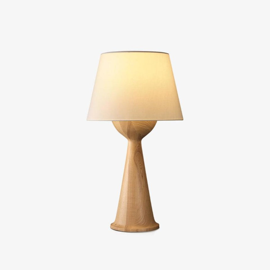 Japandi table lamp with a cloth shade on a wood hourglass base, plain background