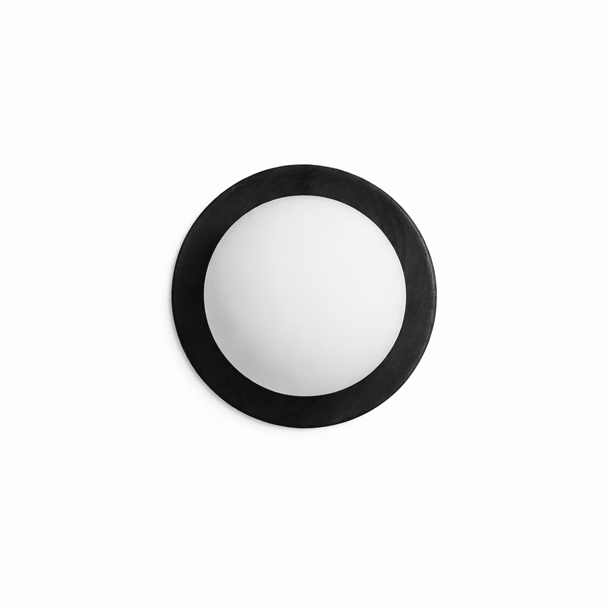 The black ring unlit, the frosted ball matte against the dark frame