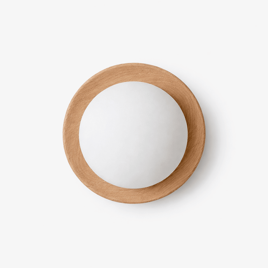 Japandi wall sconce, a pale wood ring holding a large frosted glass ball