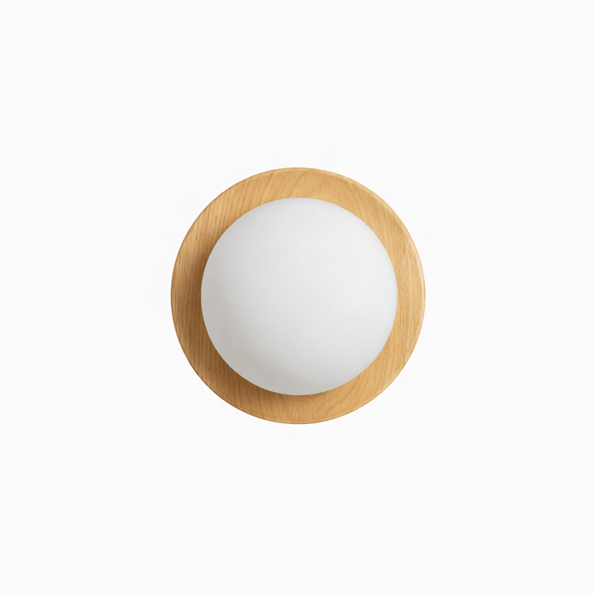 The pale wood ring seen from the front with the glass ball lit inside it
