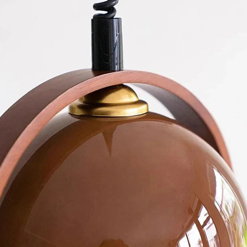 Close view of the wooden arch meeting the metal cap above the glass