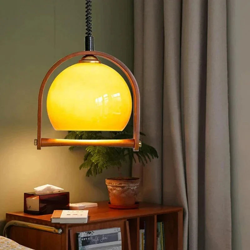 The amber dome in its wooden arch lit above a sideboard with a lamp