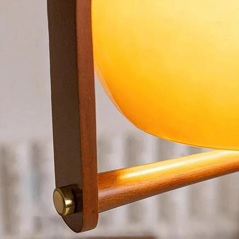 Close view of the brass pin joining the wooden arch to the shade