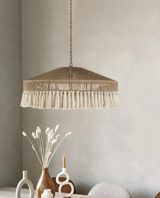 Jute pendant light hung beside an arched mirror