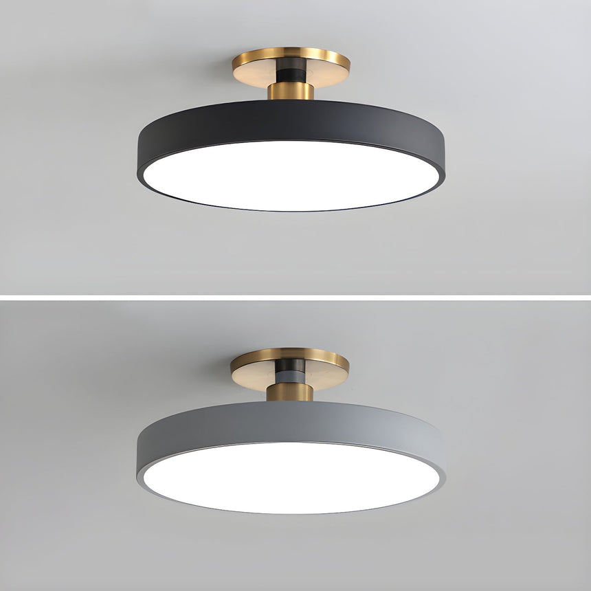 Black and gray drum ceiling lights shown on a plain backdrop