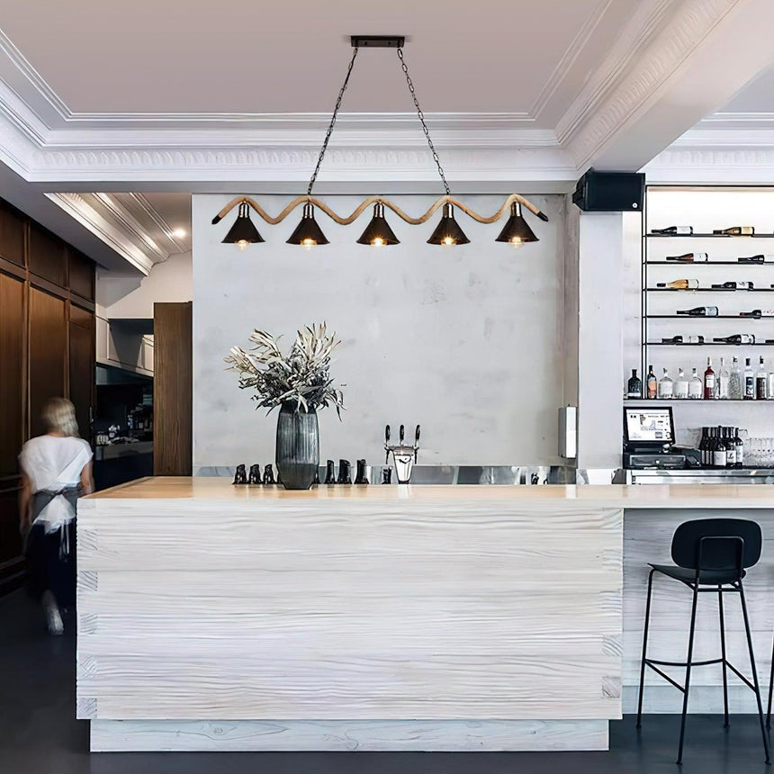 The wave lit above a pale counter with a vase and stools beside it