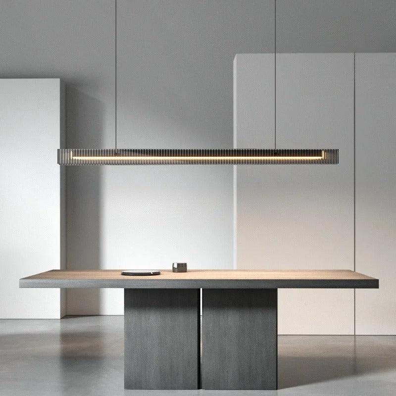 The lit bar hung above a dark table in a pale room with a counter