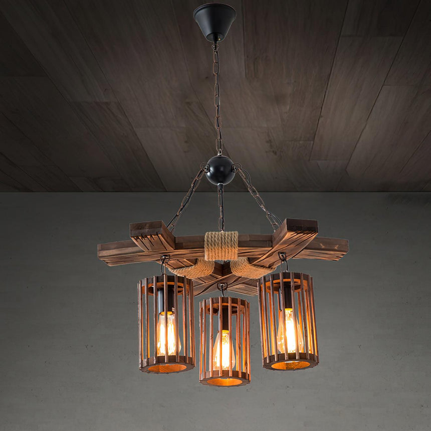 The six light chandelier lit warm against a dark plank ceiling