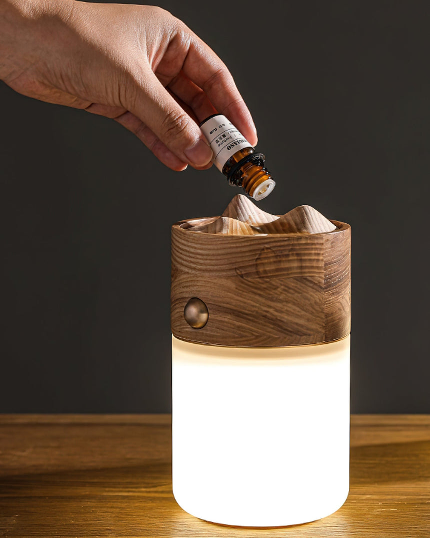 Close view of essential oil being dripped onto the carved ash wood top