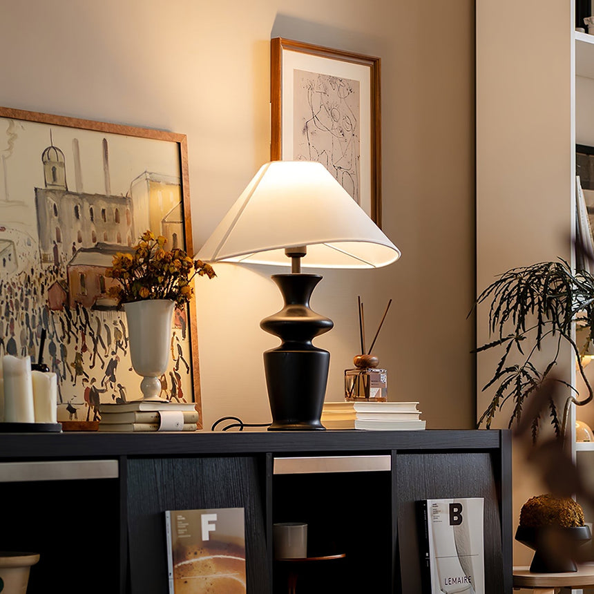 Large table lamp seen from the side, the shade wide and almost flat