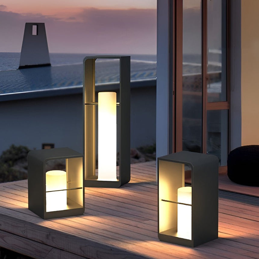 Three lit on a timber deck against a pale evening sky at dusk