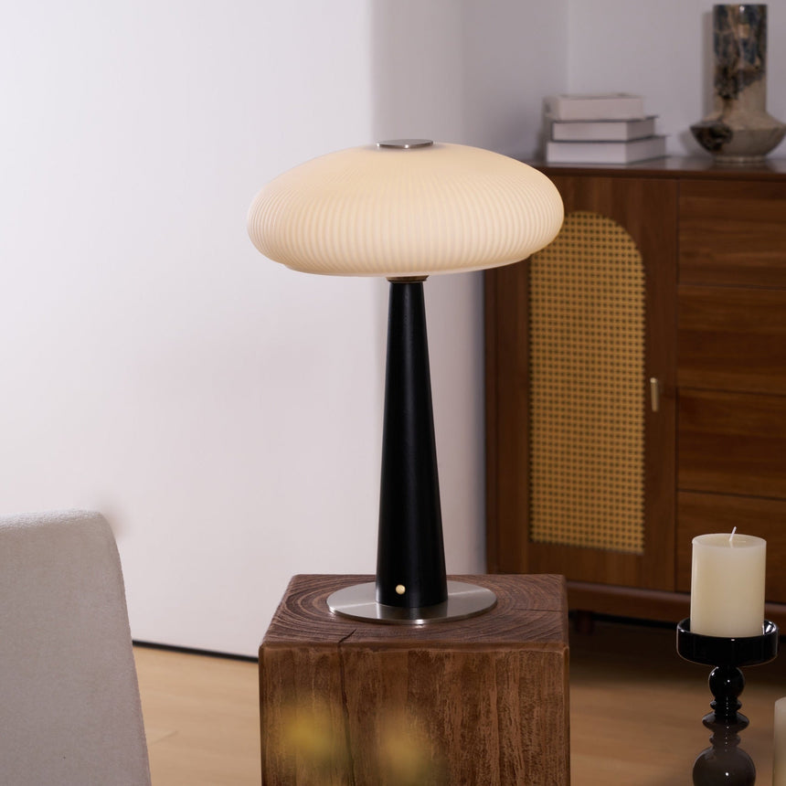 LED table lamp seen in full height against a plain pale ground