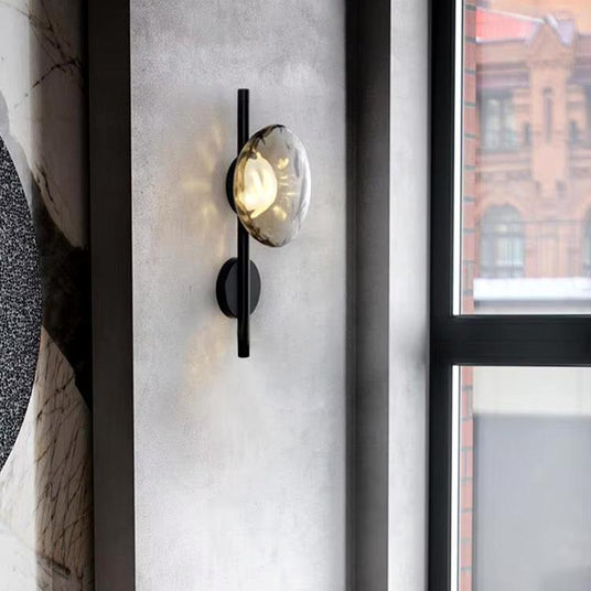 Wrought iron and glass wall sconce for entryway