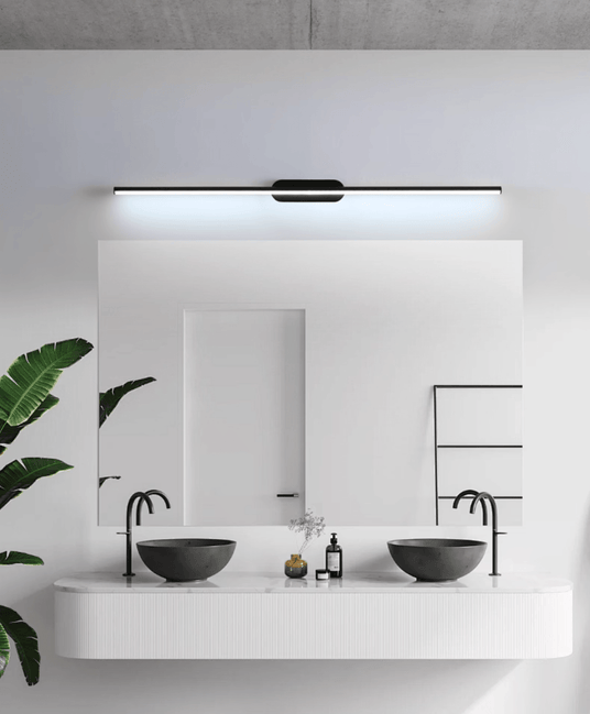 Thin rod lit above a wide mirror over two stone basins on a white counter