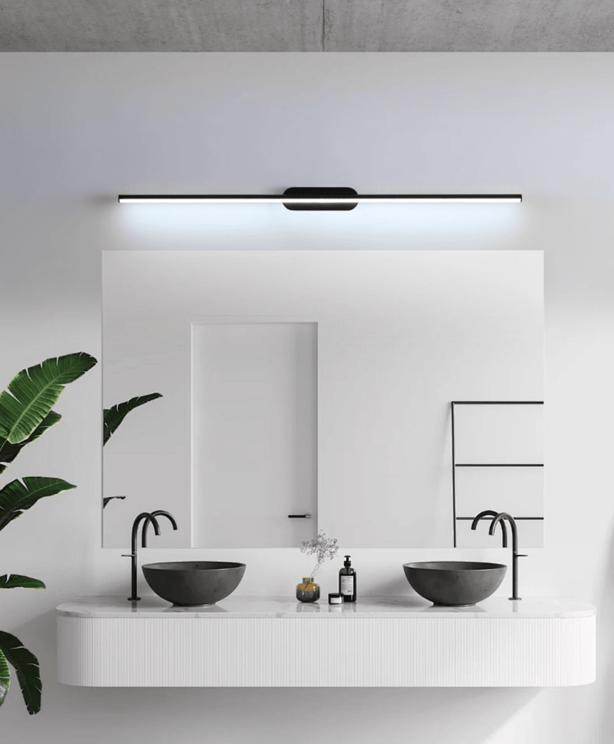 Thin rod lit above a wide mirror over two stone basins on a white counter