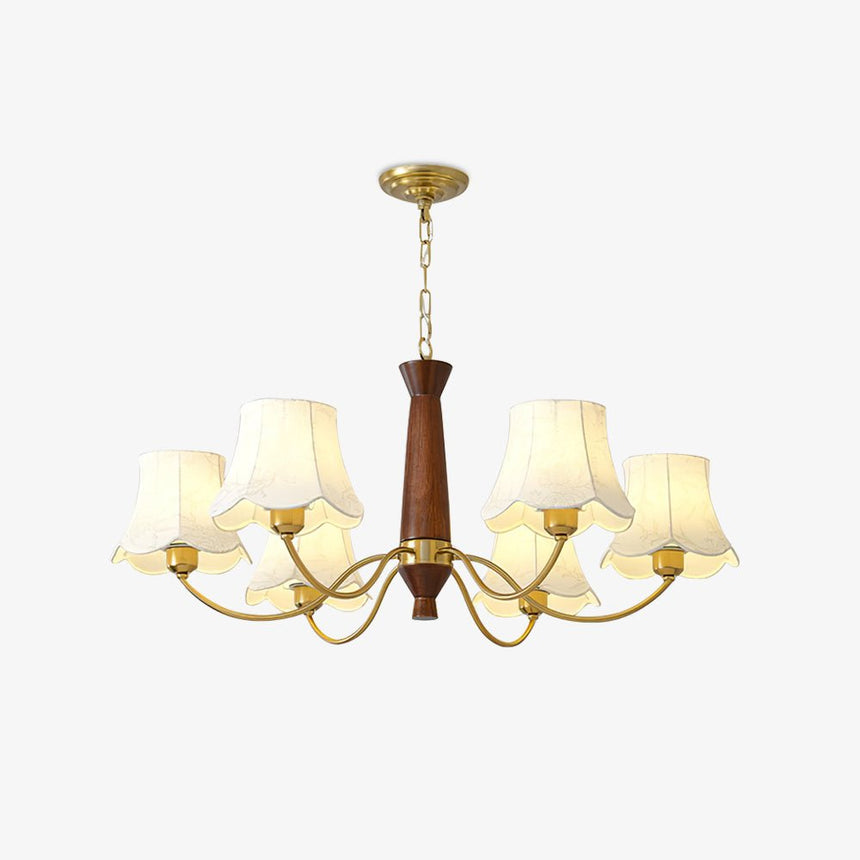 White fabric bell shades with scalloped hems on their brass arms