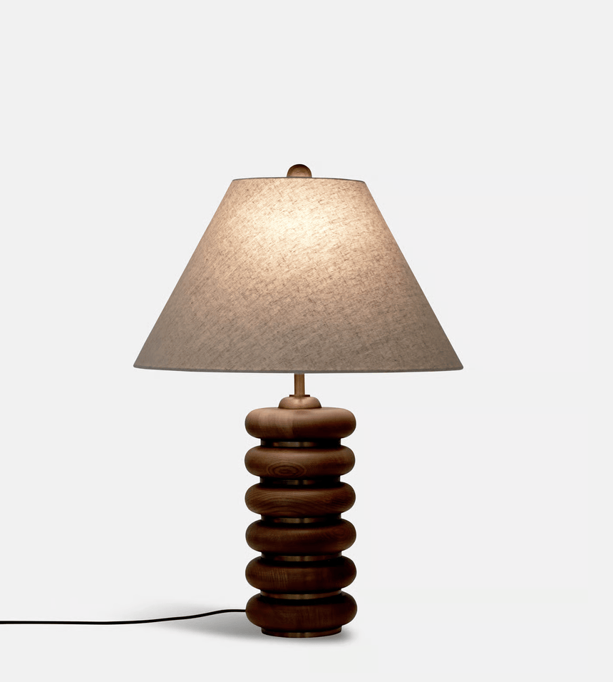 Close view of the lit linen empire shade above the wood rings