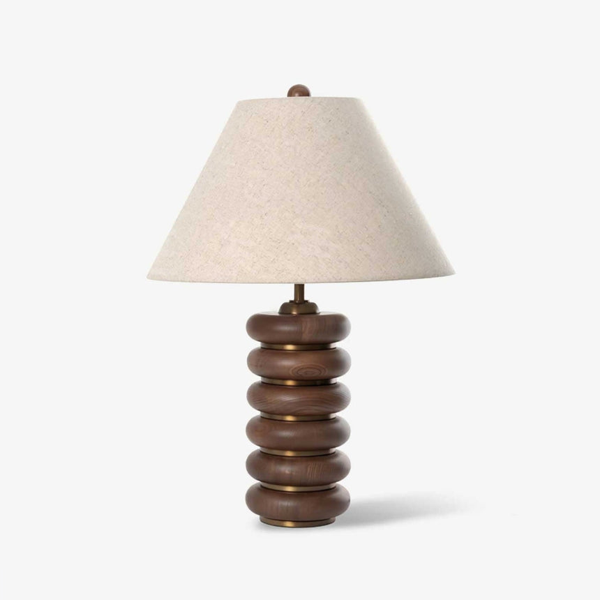 Linen shade table lamp on a column of stacked wood rings, plain ground