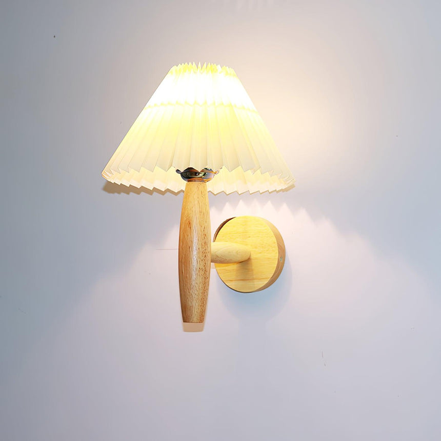 The pleated linen shade seen from the front above the turned oak arm