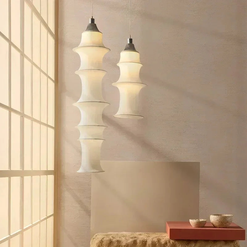 Two stacked silk columns hung at different lengths beside a staircase