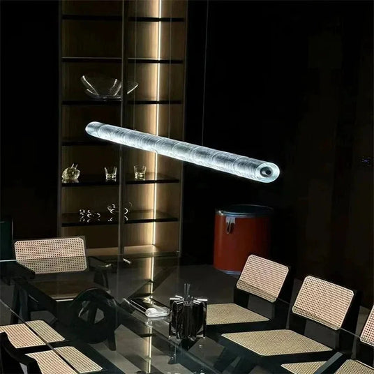 The ribbed glass bar lit above a restaurant table with glassware