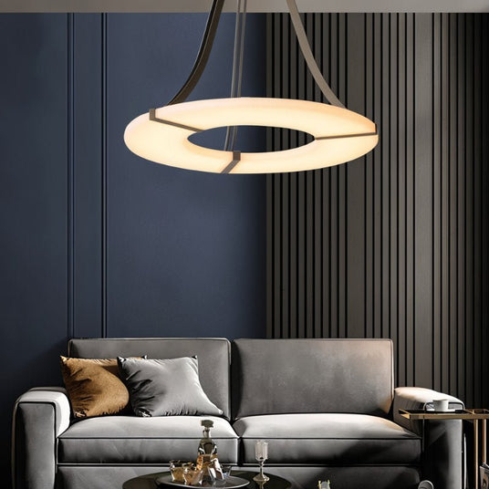 The lit ring in a living room with a sofa, cushions and a slatted dark wall