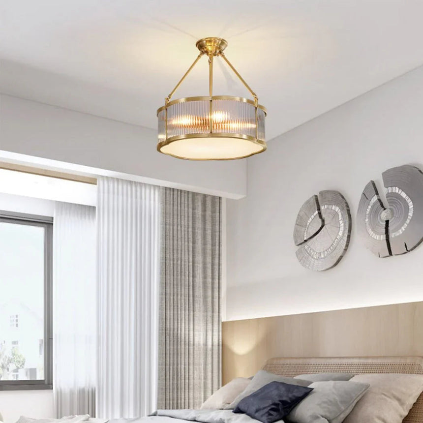 Lit drum in a bedroom with decorative plates hung on the wall opposite
