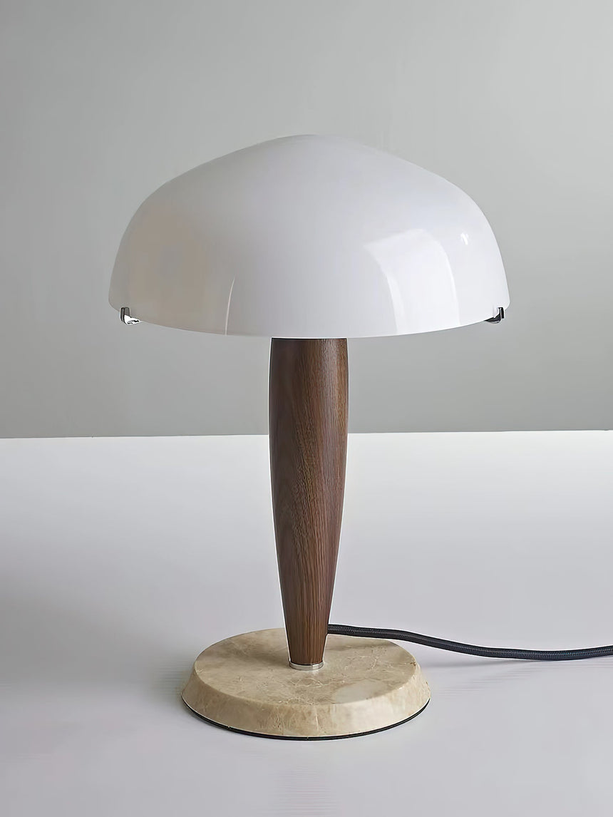 Marble base table lamp unlit, the glossy white glass dome in view