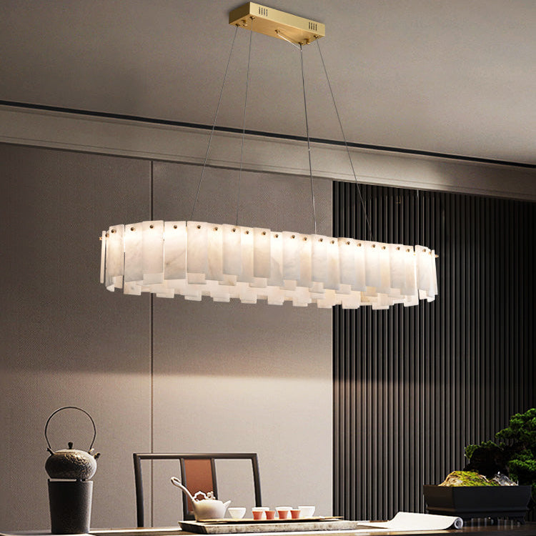 Marble ring chandelier in a room with long curtains