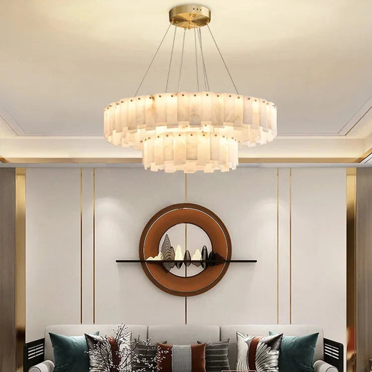 Marble ring chandelier in a living room beside a round mirror