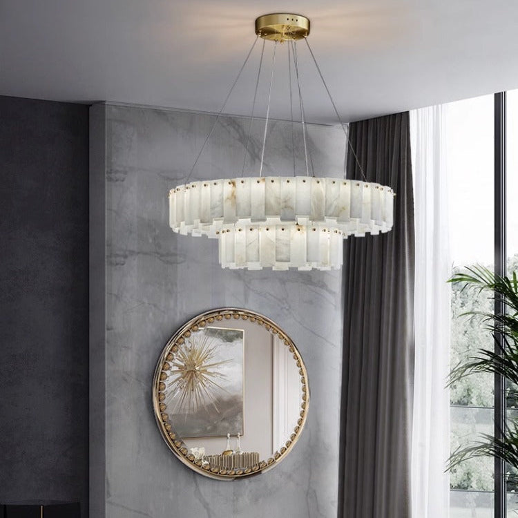 Marble ring chandelier in a room with a tall mirror