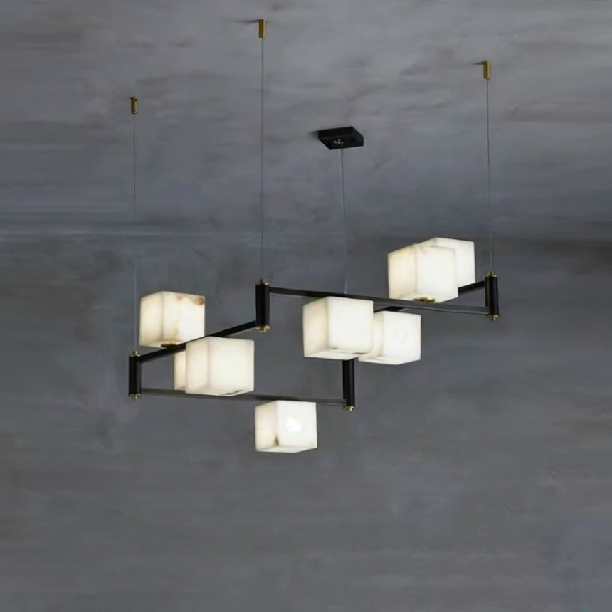 A compact staggered set of lit stone cubes on black arms and cables
