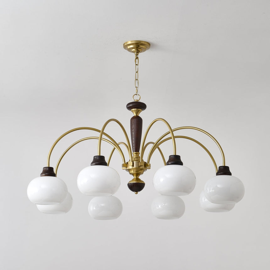 The white globes lit close, brass arms and walnut collars in view