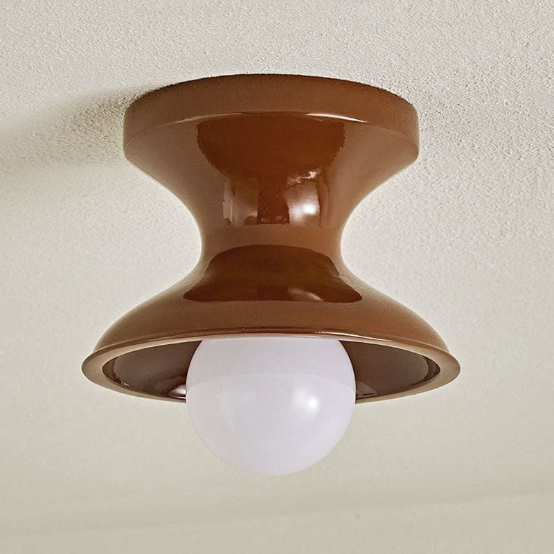 Close view of the red spool ceiling light with a round opal globe