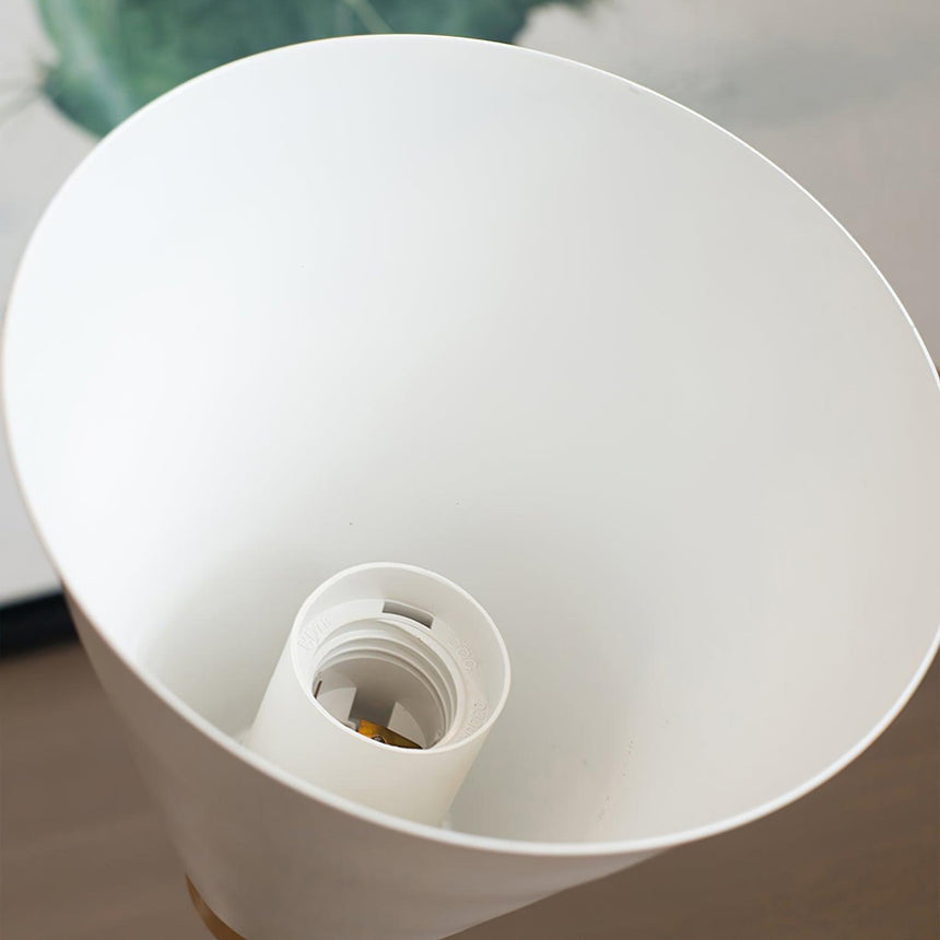 Looking up into the cone shade at the white socket waiting for a lamp