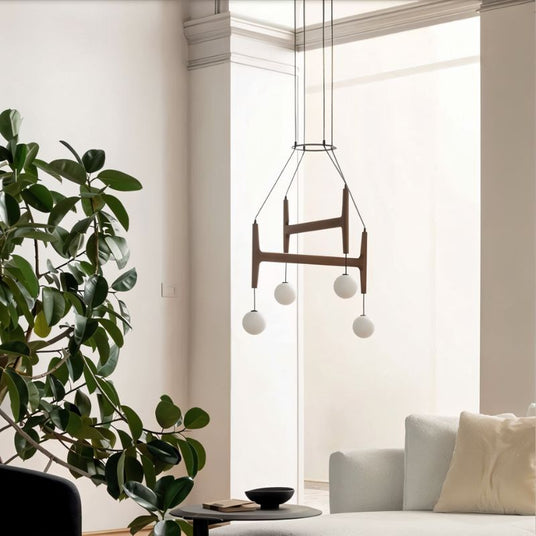 The walnut version in a living room beside a tall plant and a low sofa