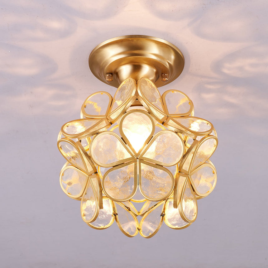 Clear glass petal ceiling light seen from the side, lit