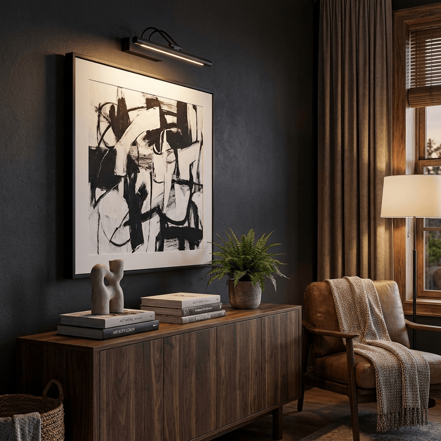 Black bar lit above a large framed print beside a plant and a low cabinet