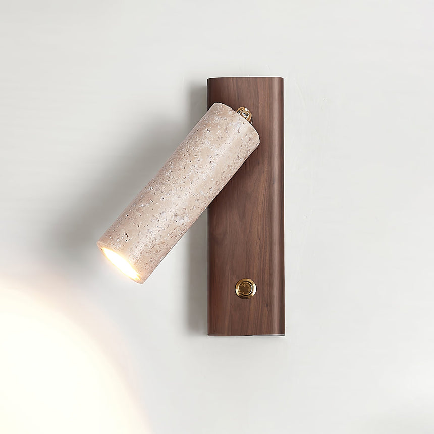 Travertine tube lit on a walnut plate, the beam washing up the wall