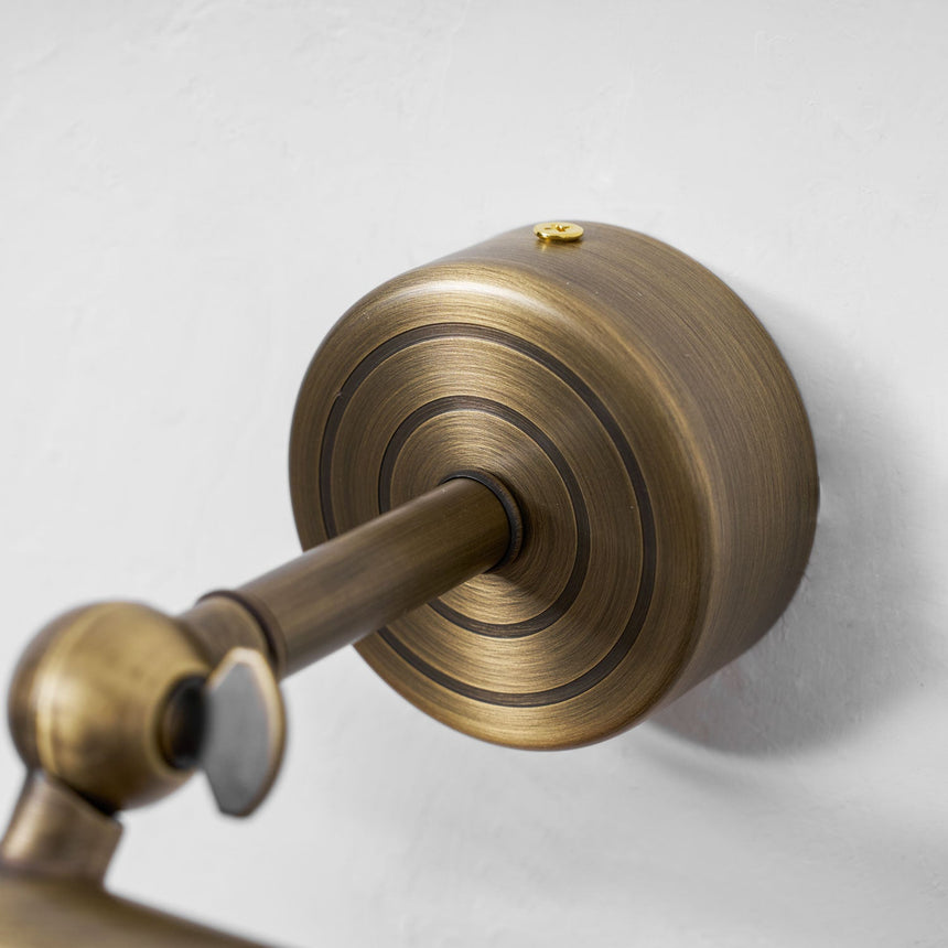Close view of the stepped bronze wall plate and the ball joint under it