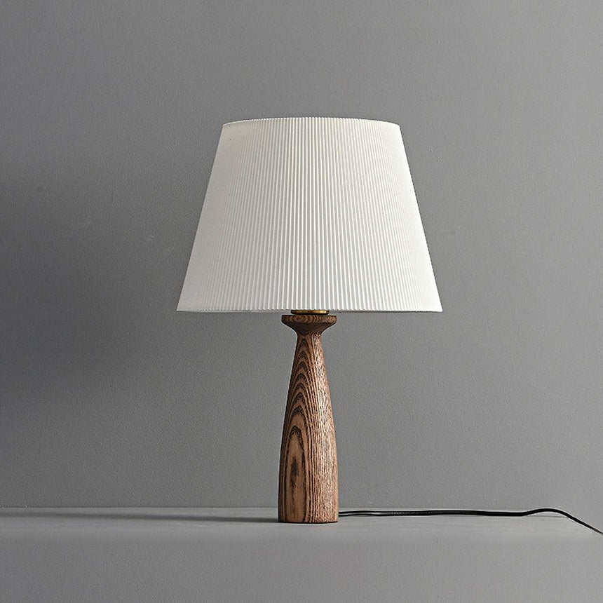 Ribbed shade lamp unlit against a gray ground, the grain clearly visible