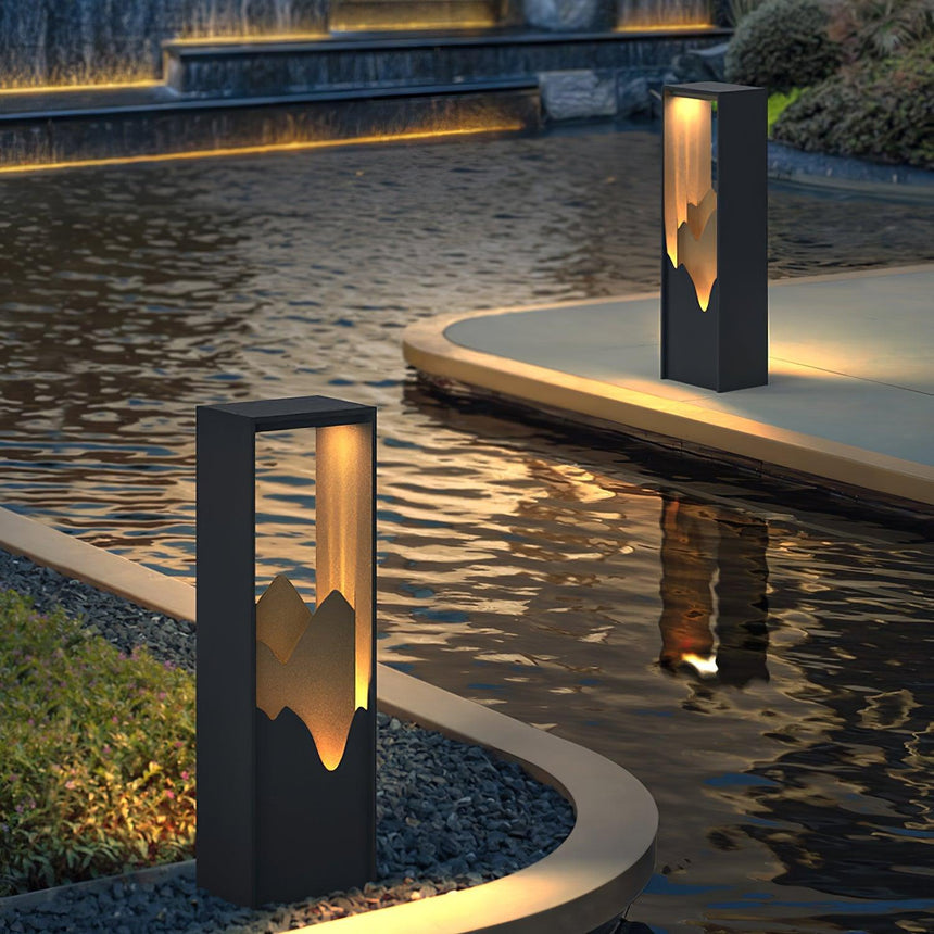 Two lit along the curved edge of a pool with a timber bench beyond