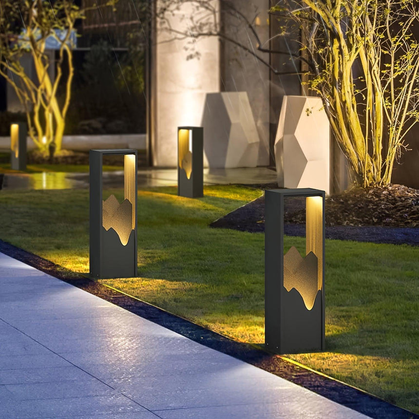 A run lit along a paved path with planting either side at dusk