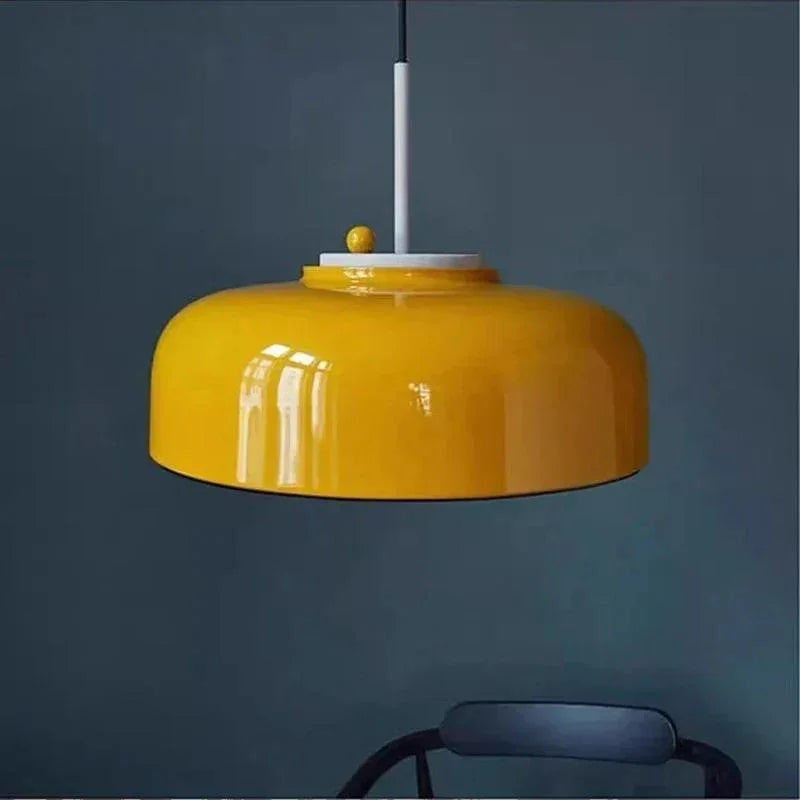 Yellow pendant lamp photographed against a deep blue wall