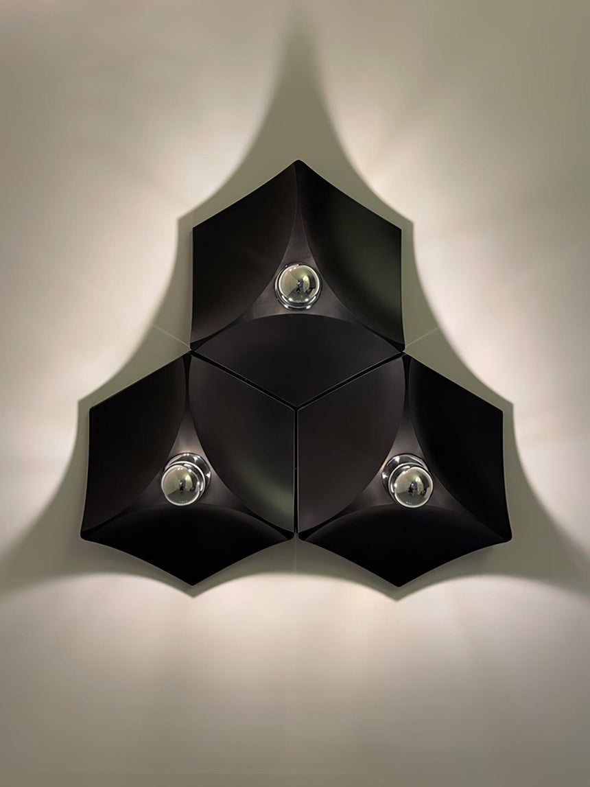 Three black lights fitted together in a triangle, lit