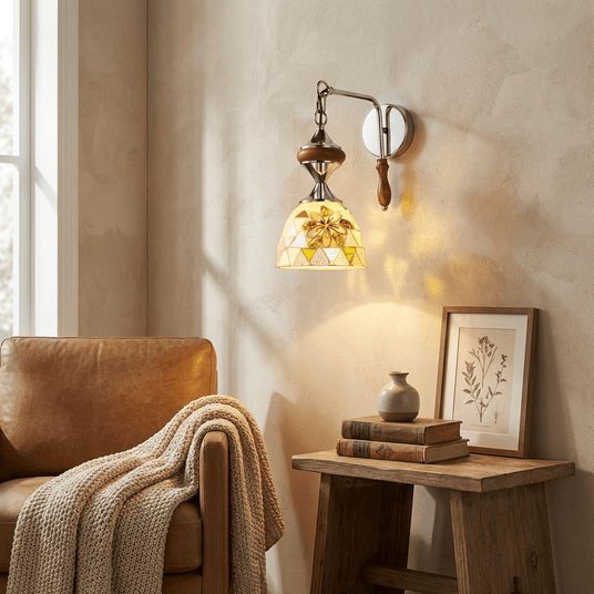 The sconce lit above a side table and a leather armchair with a knit throw