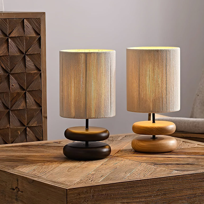 Two nightstand table lamps standing side by side on a wooden table