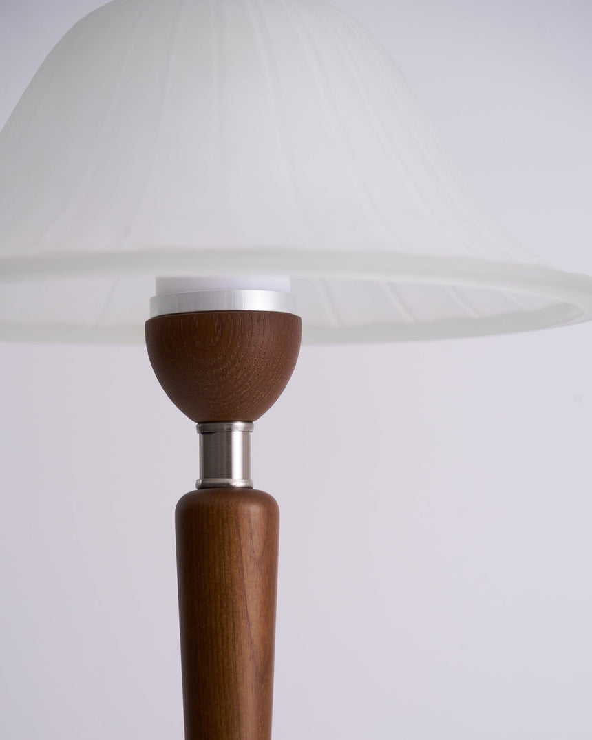 Close view of the small walnut cup where the stem meets the glass shade