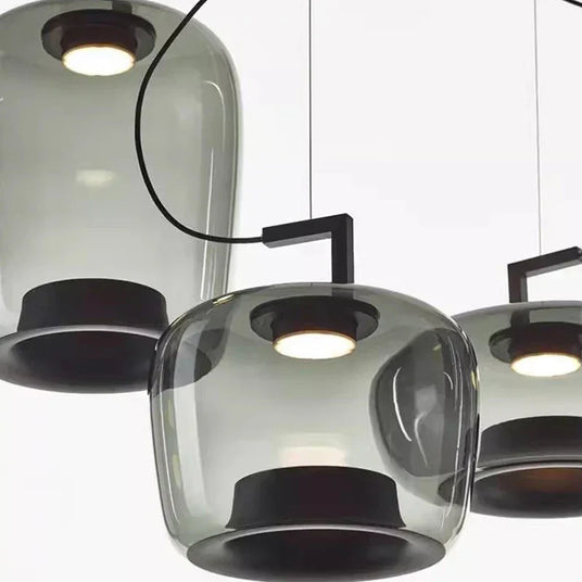 Cluster of tinted glass shades seen from below in a dark room