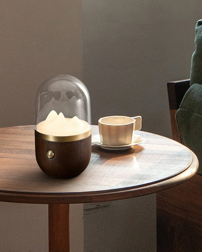 Nursery table lamp lit on a round table beside a cup of coffee